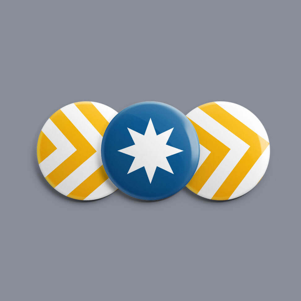 Three pins featuring the chevrons and star of the Unity Flag design